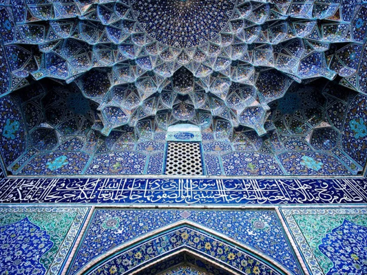 A mosque adorned with geometric and floral patterns and calligraphy tiles